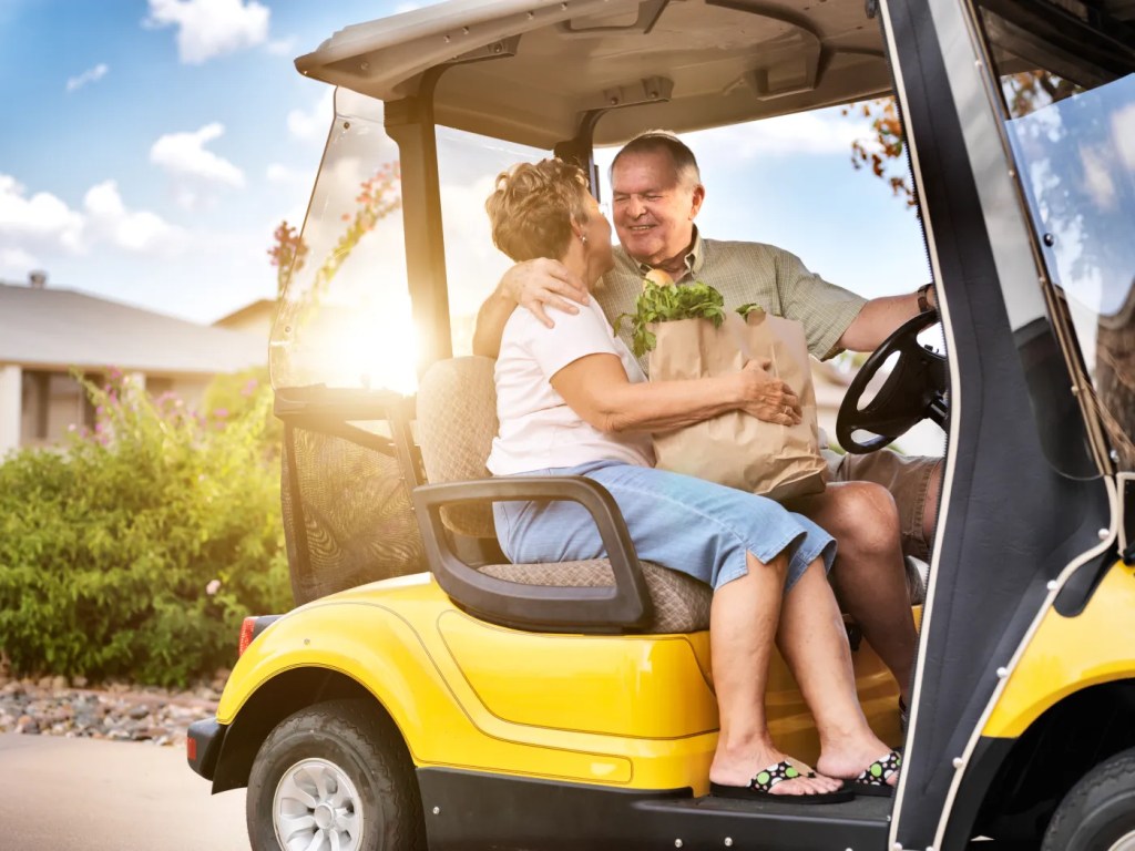 Family riding a golf cart in a Lennar community