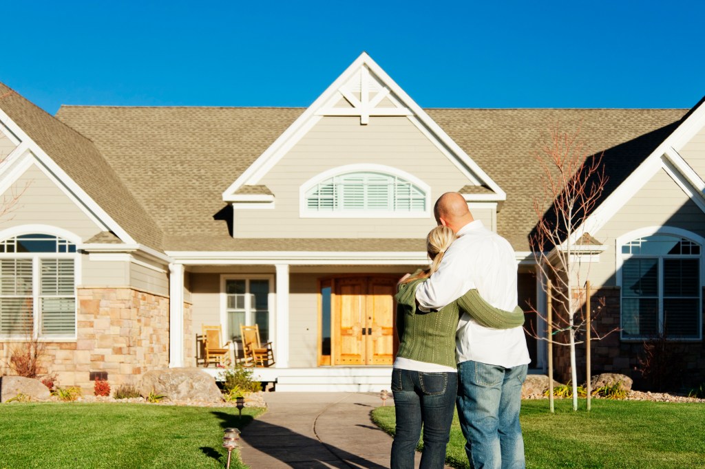 Young couple admiring their new home.